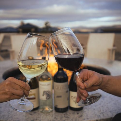 Members enjoy a glass of wine on the patio at The Club at ArrowCreek