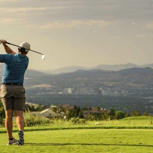 Male golfer hits a ball while golfing at The Club at Arrowcreek