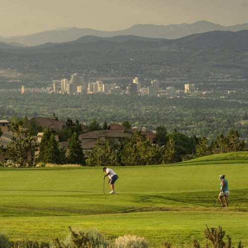 Group of golfers enjoy the beautiful Reno skyline while golfing at ArrowCreek