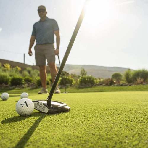 Golfers putt on one of the dual golf courses at The Club at ArrowCreek