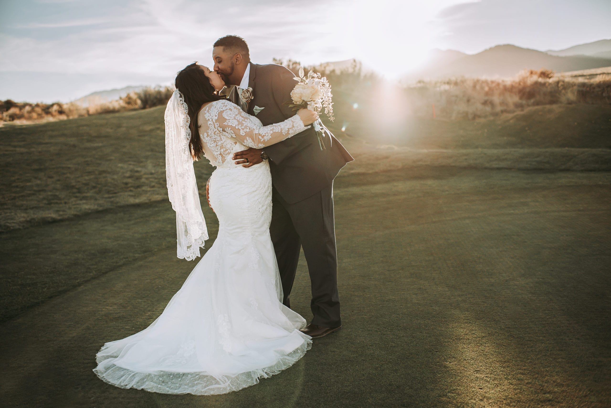 Bride and Groom kissing during thier golf course wedding at The Club at ArrowCreek