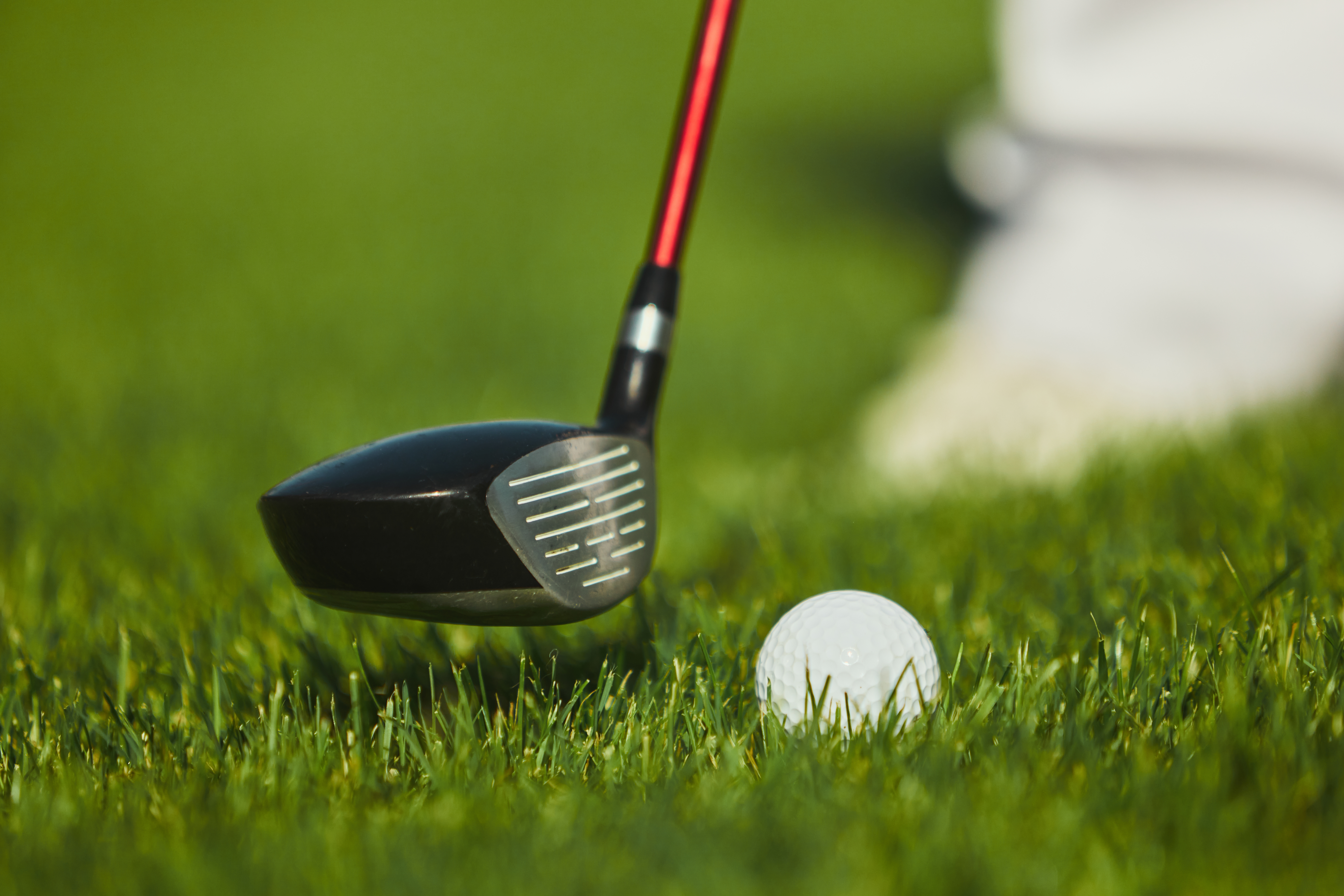 close-golf-club-head-ball-on-field